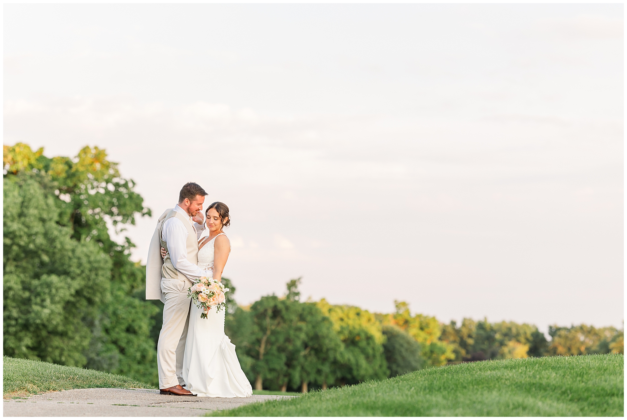 Bride and Groom on their wedding day at Cantigny Park. Image taken during golden hour. Photo by Rachael Watson, Chicagoland Wedding Photographer.